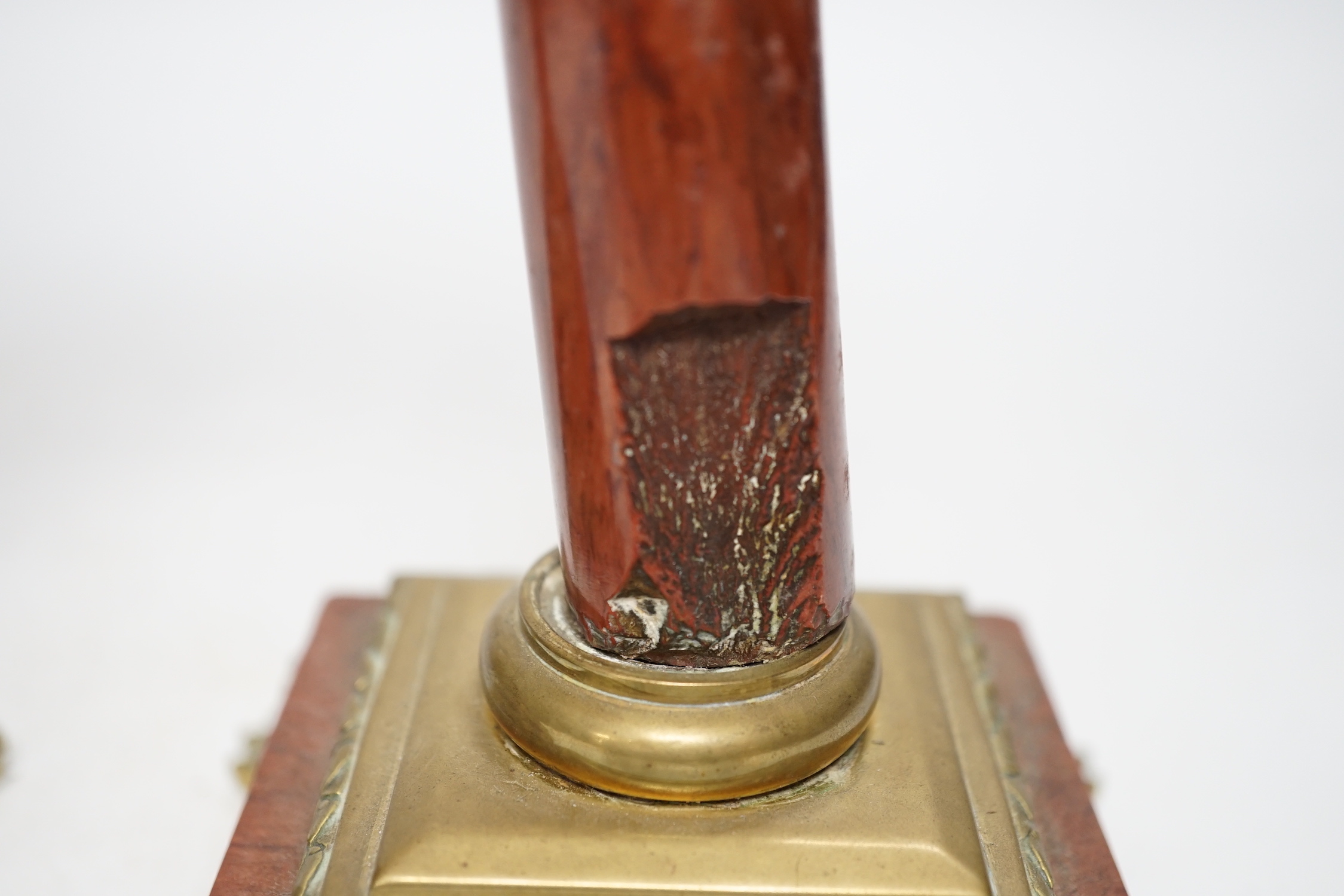 A pair of 19th century brass mounted rouge marble candlesticks, 29cm (a.f.)